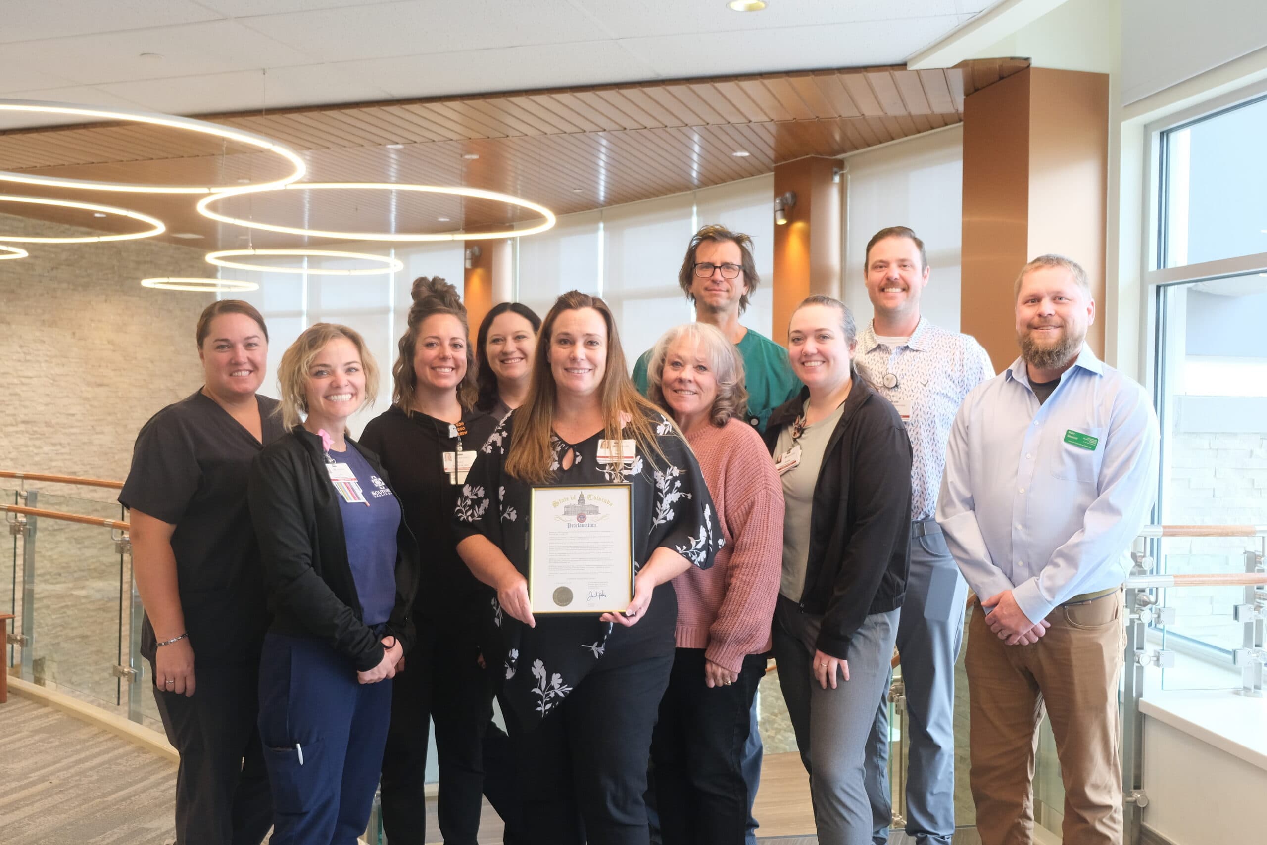 Southwest Health System staff in Cortez stand together as one of them holds the State of Colorado proclamation for National Rural Health Day.